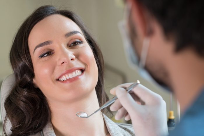 38774755 – closeup of dentist visiting a patient in clinic